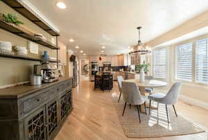 Dining room with a chandelier and light hardwood / wood-style floors