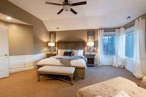 Bedroom featuring lofted ceiling, light colored carpet, and ceiling fan