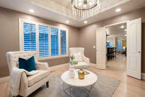 Living area featuring a chandelier and light wood-type flooring