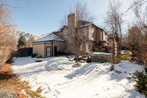 Snow covered property with a mountain view