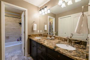 Bathroom featuring vanity and shower / bath combination with curtain