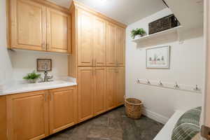 Clothes washing area featuring sink