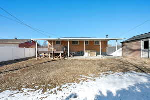 Snow covered property with a wooden deck