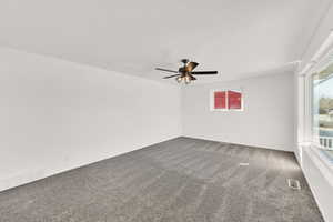 Unfurnished room with ceiling fan and carpet