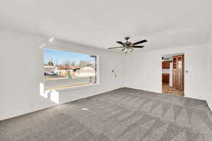 Interior space featuring ceiling fan and light colored carpet