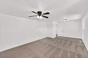 Empty room with carpet flooring and ceiling fan