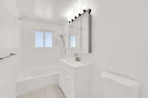 Full bathroom featuring vanity, tile patterned floors, bathing tub / shower combination, and toilet