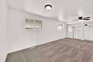 Carpeted spare room with a textured ceiling