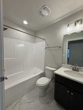 Full bathroom featuring vanity, a textured ceiling, shower / washtub combination, and toilet