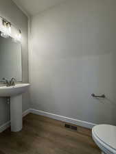 Bathroom with toilet and hardwood / wood-style floors