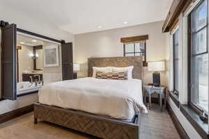 Bedroom with a barn door and carpet