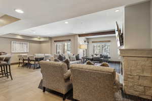 Living room with beamed ceiling and light hardwood / wood-style flooring