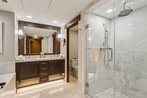 Bathroom featuring vanity, toilet, and walk in shower