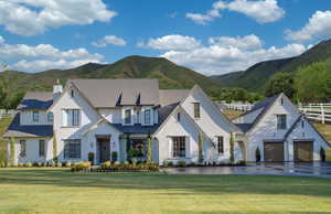 View of front of property featuring a mountain view and a front lawn