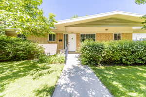 Single story home with a front yard