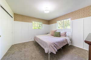 Bedroom featuring light colored carpet