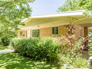 View of property exterior with a yard