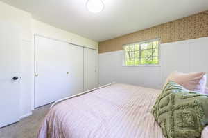 Bedroom featuring carpet flooring and a closet