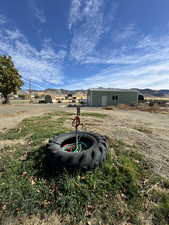 View of yard with a mountain view and an outbuilding