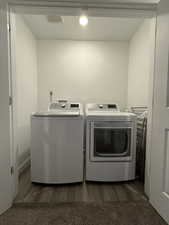 Washroom featuring dark hardwood / wood-style flooring and independent washer and dryer