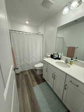 Bathroom featuring vanity, hardwood / wood-style flooring, toilet, and a textured ceiling