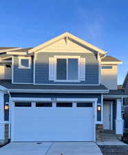 View of front facade featuring a garage