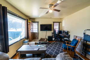 Living room with hardwood / wood-style flooring and ceiling fan