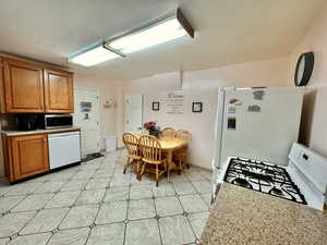 Kitchen featuring white appliances