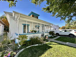 View of front of property with a front lawn and covered porch