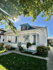 Bungalow-style house with a front yard and covered porch