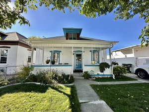 Bungalow-style house with a front yard and covered porch