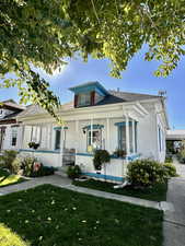 Bungalow-style house featuring a front lawn and covered porch