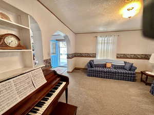 Carpeted living room with crown molding