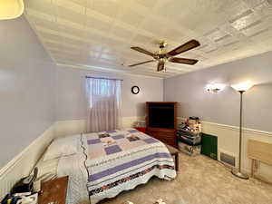 Bedroom with ceiling fan and carpet floors