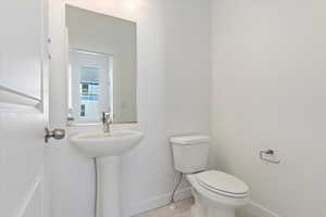 Bathroom featuring sink and toilet