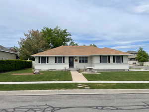 Ranch-style home featuring a front yard