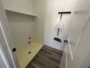 Laundry room with electric dryer hookup and dark hardwood / wood-style floors