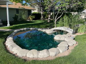 View of pool with a yard