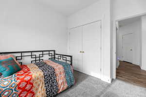 Carpeted bedroom with a closet