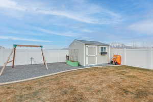 View of outbuilding with a lawn