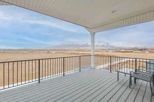 Wooden deck featuring a rural view and a mountain view