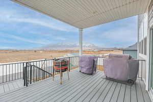 Deck featuring a mountain view and a grill