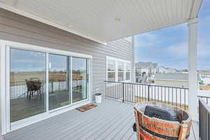 Wooden deck featuring an outdoor fire pit