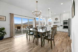 Dining area featuring a mountain view, sink, a chandelier, and light wood-type flooring