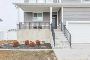 View of exterior entry with covered porch