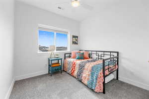 Carpeted bedroom with ceiling fan