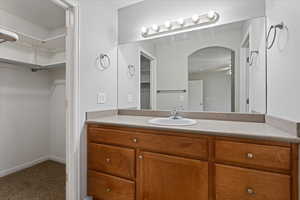 Bathroom featuring ceiling fan and vanity