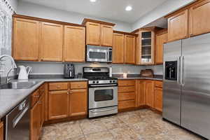 Kitchen featuring appliances with stainless steel finishes and sink