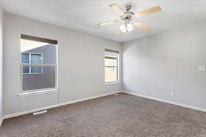 Spare room with ceiling fan and carpet