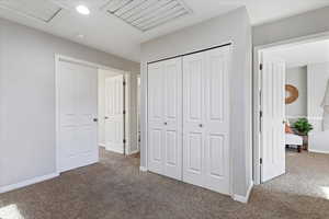 Unfurnished bedroom with dark colored carpet and a closet